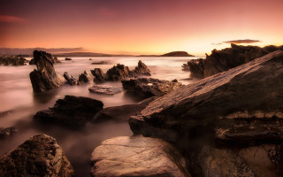 Sunset rocky beach mountains cityscape - moody free wallpaper