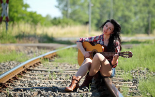 Woman sitting train track guitar - a train track free wallpaper for desktop
