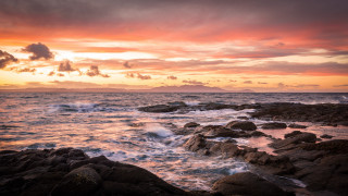 Sunset ocean rocks waves mountain - moody free wallpaper