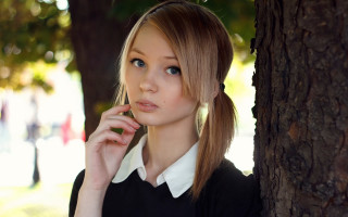 Woman tree phone serious gothic - her face and shoulder free wallpaper