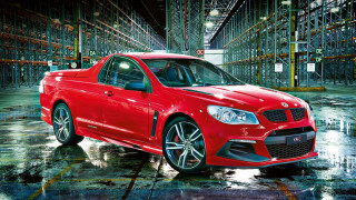 Red car warehouse pallets cityscape - a warehouse free wallpaper