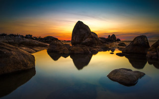 Sunset water rocks building sky - a sky in the background free wallpaper