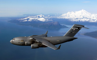 Military plane over water mountains - a large military plane free wallpaper