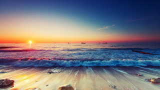 Sunset ocean waves boats beach - a sunset over the ocean free wallpaper for desktop