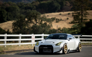 White sports car driving road 2 - a white fence free wallpaper