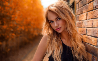 Blonde woman brick wall autumn - a woman leaning against a brick wall free wallpaper