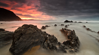 Rocky beach sunset clouds mountain - dark cloud free wallpaper