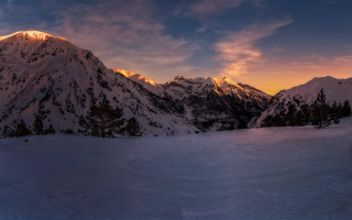 Snowy mountain range cloudy sunset 2 - snow under a cloudy sky free wallpaper