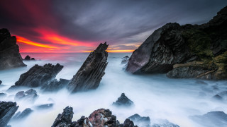 Rocky beach red sky clouds - the water below free wallpaper