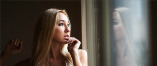 Blonde woman window posing portrait - her chin free wallpaper