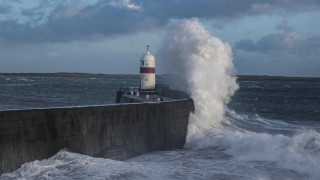 Lighthouse wave ocean concrete wall - a concrete wall free wallpaper