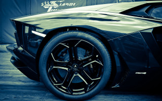 Black sports car veena x - a sign behind free wallpaper