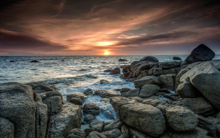 Sunset ocean rocks water cloudy - a sunset over the ocean free wallpaper for desktop