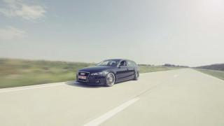 Black car driving road grass 2 - a field of grass and trees free wallpaper