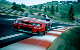 Red car racing green hill - a race track free wallpaper