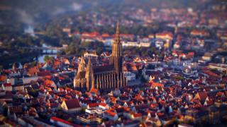 City cathedral river trees foreground - tilt shift free wallpaper for desktop
