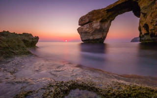 Rock arch sunset ocean landscape - a rock formation in the ocean free wallpaper