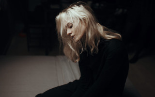 Woman sitting bed blowing hair - somber free wallpaper