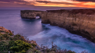 Sunset rocky cliff water bush - anson maddock free wallpaper