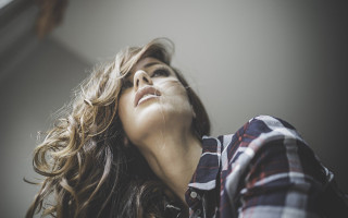 Woman blowing hair eyes closed - the wind free wallpaper