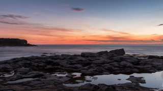 Sunset ocean rocks water cliff - widescreen free wallpaper