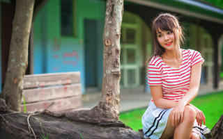 Woman sitting tree branch building 2 - a blue building free wallpaper