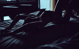 Woman laptop bed window dark - a laptop free wallpaper