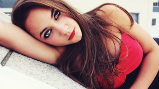 Woman longhair redshirt lying ledge - a ledge free wallpaper