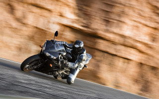 Man motorcycle curvy road rockwall - motion blur free wallpaper