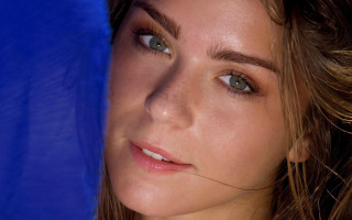 Woman blue umbrella serious face - shaded free wallpaper