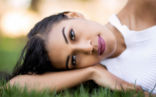 Woman laying on grass blurry - daphne allen free wallpaper