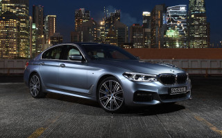 Silver car city skyline night 9 - a city skyline in the background free wallpaper