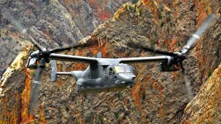 Military helicopter flying mountain stream - the valley free wallpaper