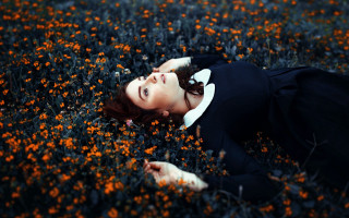 Woman laying flowers eyes closed - a bun free wallpaper