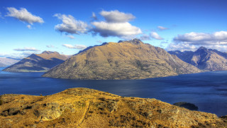 Mountain range lake bridge sky - the foreground and a mountain range in the background free wallpaper