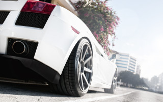 White sports car tiltshift city 2 - the rear end of the car free wallpaper