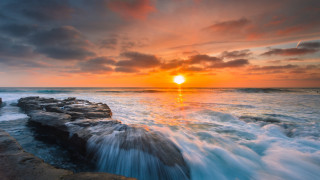 Sunset ocean waves rocks person - a sunset over the ocean free wallpaper for desktop
