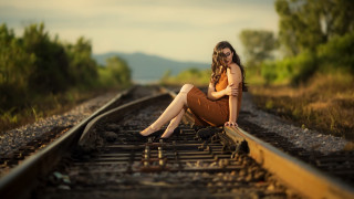 Woman sitting train track bokeh - a train track free wallpaper