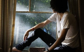 Man sitting window sill looking - single body free wallpaper