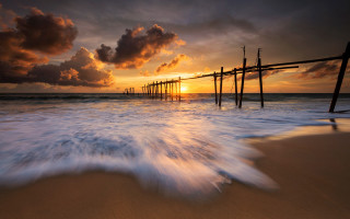 Pier waves sunset clouds beach - a pier free wallpaper