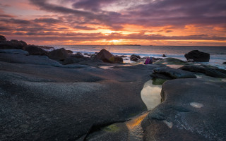Sunset rocky beach people cliffs - the water and a person free wallpaper