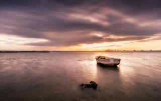 Boat beach cloudy sunset rock - top of a beach under a cloudy sky free wallpaper