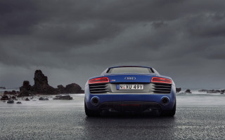 Blue car ocean wet road 2 - the ocean under a cloudy sky free wallpaper