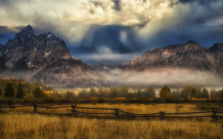 Fence field mountains clouds sunset - in a field free wallpaper