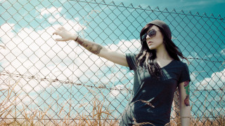 Woman hat sunglasses fence outstretched - a hat and sunglasses free wallpaper