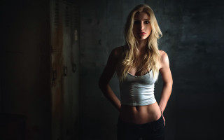 Woman white top dark room 2 - a white top free wallpaper