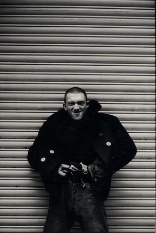 Man standing garage door smiling - derek jarman free wallpaper