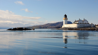Lighthouse rocky shore mountains water - archibald skirving free wallpaper