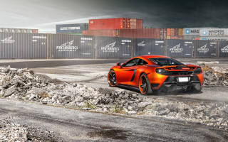Orange sports car shipping container - a pile of rocks free wallpaper