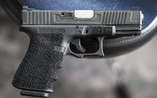 Gun table blurry background detailed - a close up of a gun free wallpaper